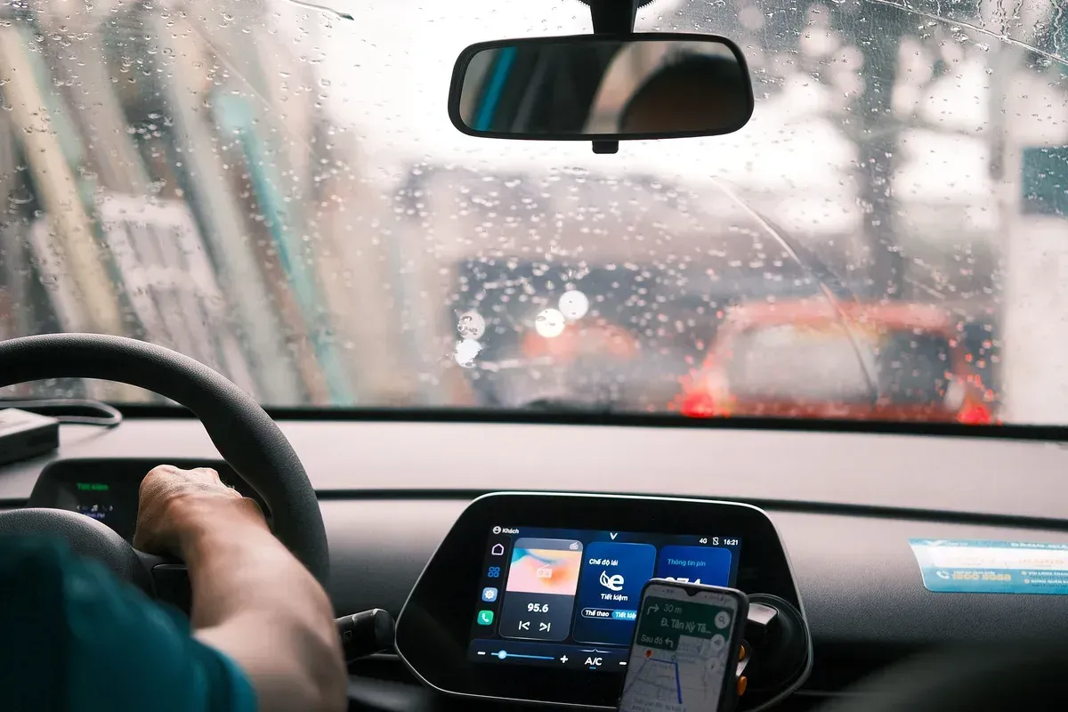 Rainy-road view through moving wipers